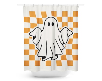 May include: A white shower curtain with a black and white ghost illustration on an orange and white checkered background.