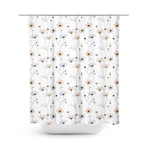 May include: White shower curtain with a delicate floral pattern. The design features stylized flowers in pastel pink, yellow, and lavender, with black accents and thin gray stems. The curtain is hanging from a silver rod.