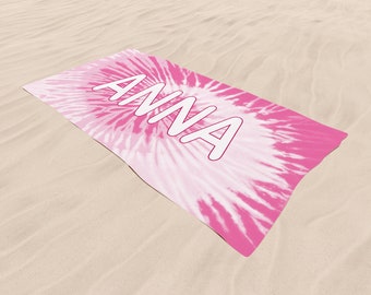May include: Pink and white tie-dye beach towel with the name "ANNA" printed in white.