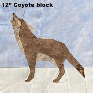 May include: A 12-inch coyote block quilt square. The coyote is brown and tan, howling against a light blue sky. The background is a patchwork of light blue and white fabric.