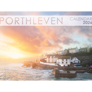 May include: A 2026 calendar with the word 'Porthleven' at the top, showcasing a coastal landscape. The image depicts a sunset over the sea, with buildings lining the shore. The sky is filled with orange and pink colours.