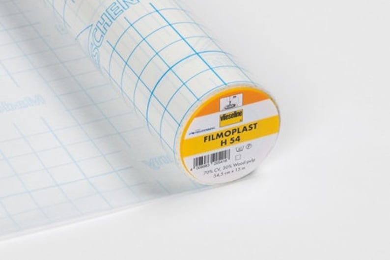 May include: A roll of clear adhesive film with a grid pattern. The label reads "FILMOPLAST H 54" and includes details like "70% CV, 30% Wood pulp" and "54.5 cm x 15 m".