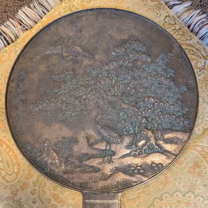 Antique Japanese Kagami - Bronze Antique Hand Mirror - Flying Cranes Turtle, Pine Trees, Pond Theme Meiji or Taishō Period 1868-1926
This piece roughly from the Meiji period (1868-1921) or Taisho period (1921-1926) is a Japanese bronze