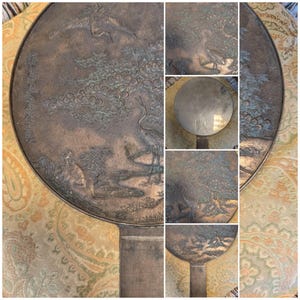 Antique Japanese Kagami - Bronze Antique Hand Mirror - Flying Cranes Turtle, Pine Trees, Pond Theme Meiji or Taishō Period 1868-1926
This piece roughly from the Meiji period (1868-1921) or Taisho period (1921-1926) is a Japanese bronze