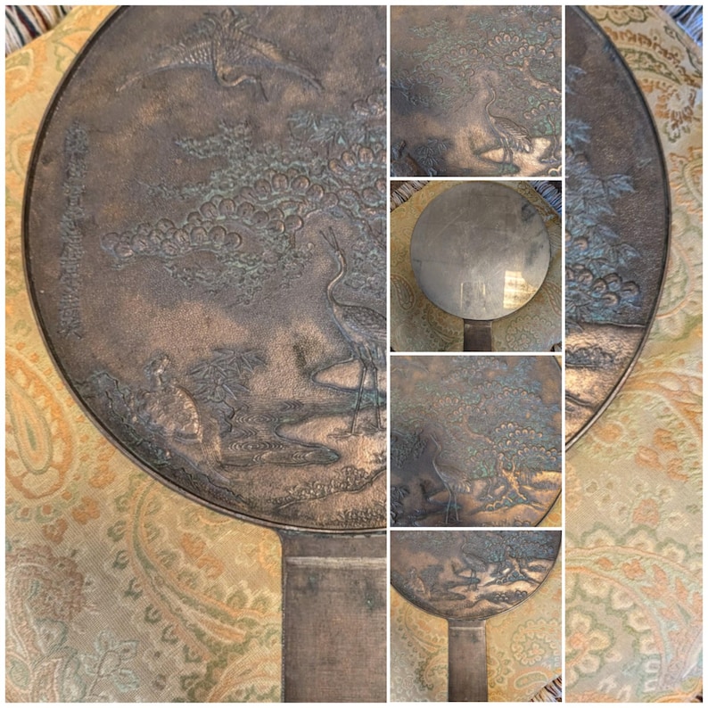 Antique Japanese Kagami - Bronze Antique Hand Mirror - Flying Cranes Turtle, Pine Trees, Pond Theme Meiji or Taishō Period 1868-1926
This piece roughly from the Meiji period (1868-1921) or Taisho period (1921-1926) is a Japanese bronze