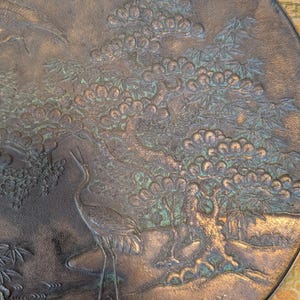 Antique Japanese Kagami - Bronze Antique Hand Mirror - Flying Cranes Turtle, Pine Trees, Pond Theme Meiji or Taishō Period 1868-1926
This piece roughly from the Meiji period (1868-1921) or Taisho period (1921-1926) is a Japanese bronze