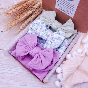 May include: A set of three hair bows in a gift box. The bows are made of soft fabric and come in a variety of colors and patterns. The bows are perfect for adding a touch of style to any outfit.