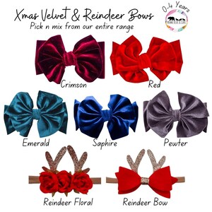 May include: A collection of seven hair accessories labeled Xmas Velvet & Reindeer Bows 0-4 years. Includes velvet bows in crimson, red, emerald, sapphire, and pewter, plus two reindeer-themed headbands with floral or bow accents and glittery antlers.