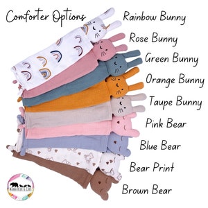 May include: A stack of 10 baby comfort blankets with different animal designs. The designs include a rainbow bunny, rose bunny, green bunny, orange bunny, taupe bunny, pink bear, blue bear, bear print, and brown bear. The blankets are made of soft, breathable fabric and are perfect for cuddling.