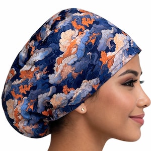 May include: A navy blue scrub cap featuring a pattern of orange, light blue, and grey cloud-like shapes. The cap is made of a soft, flexible material and is designed to cover the hair.