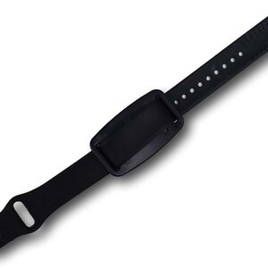 Back side view of a nvs magnetic on a black silicone pin and tuck bracelet band.