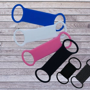 May include: Five silicone wristbands in blue, white, pink, black, and black with a woven texture. The wristbands have a loop on each end.