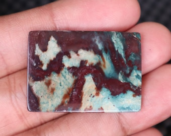May include: A rectangular slab of polished agate with a swirling pattern of brown, white, and green.