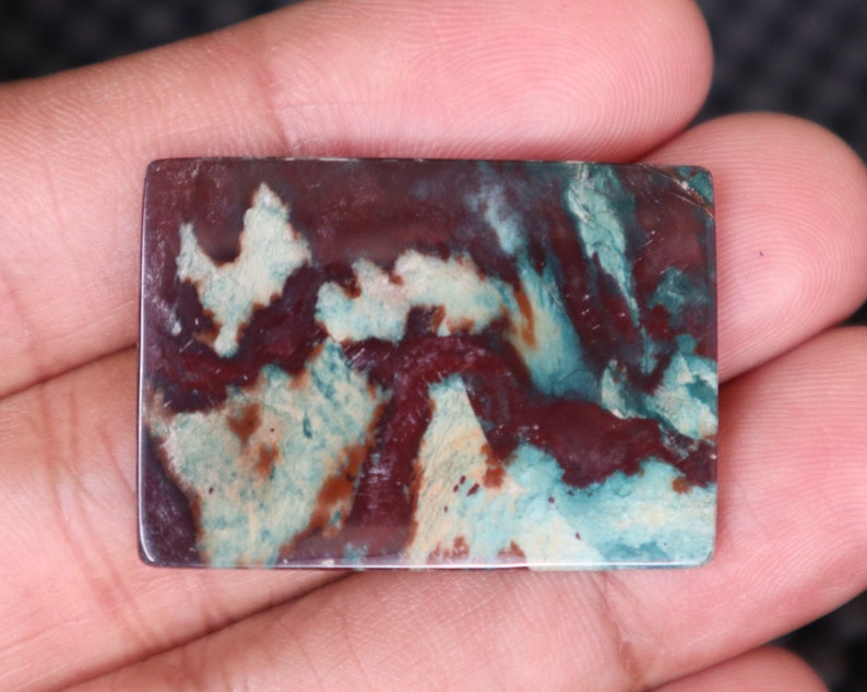 May include: A rectangular slab of polished agate with a swirling pattern of brown, white, and green.