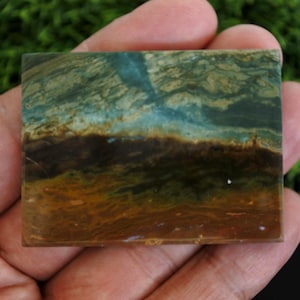 May include: A trio of cream-glazed ceramic mugs, each adorned with a hand-painted floral pattern in blue, green, and yellow hues. The mugs have a speckled finish and a minimalist design with easy-grip handles.