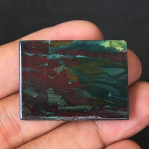 May include: A rectangular piece of polished green, red, and brown jasper with a swirling pattern.