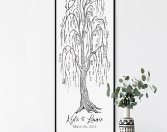 May include: A black and white illustration of a weeping willow tree with names written on the branches. The tree is framed in a black frame and hangs on a white wall above a wooden console table with two woven baskets. The text below the tree reads "Kyle & Lauren March 30, 2021".