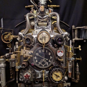 May include: A steampunk-style clock with a variety of gears, dials, and gauges. The clock face is surrounded by a metal frame with a red star and a compass. The clock is made of metal and has a distressed finish.