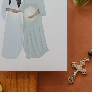May include: A digital illustration of two women in long, flowing robes. One woman is pregnant and holding her belly. The other woman is standing next to her with her hand on the pregnant woman's belly.