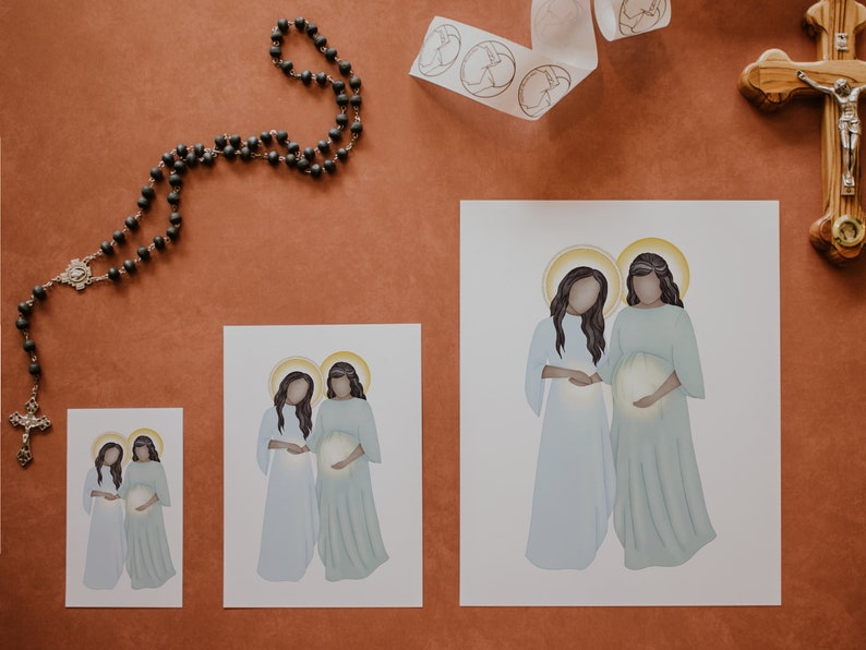 May include: Three different sizes of prints featuring a digital illustration of two women in white and blue robes, holding a glowing orb. The women have dark hair and are standing side-by-side.