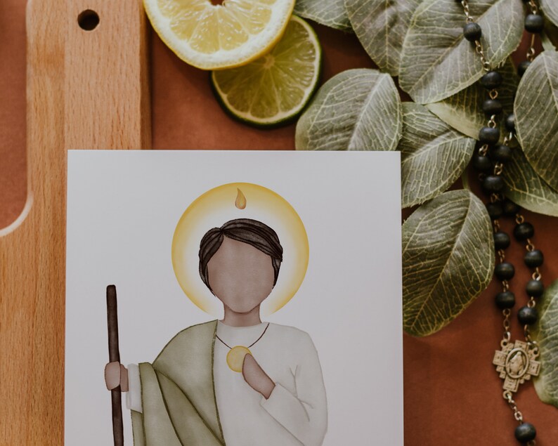May include: A watercolor illustration of a saint with a halo, holding a staff. The saint is wearing a green robe and a white tunic. The background is white.