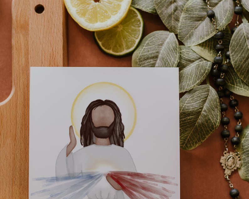May include: A watercolor painting of Jesus Christ with a halo, wearing a white robe and raising his right hand. The painting depicts the Divine Mercy image with red and blue rays emanating from his chest.