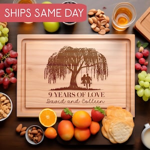May include: A wooden cutting board with a personalized engraving that reads "9 Years of Love David and Colleen". The engraving features a silhouette of a couple sitting under a weeping willow tree.