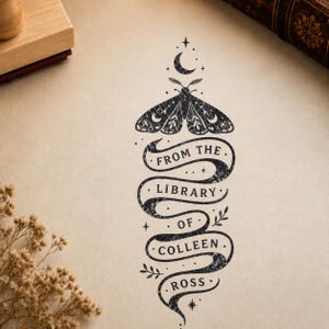 May include: A black ink stamp design on light paper featuring a moth at the top with a crescent moon and stars. Below the moth is a winding ribbon banner containing the text FROM THE LIBRARY OF COLLEEN ROSS, accented with small leaf sprigs.