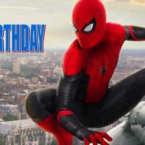 May include: A red and black superhero costume with a spider logo. The superhero is standing on a metal structure with a city skyline in the background. The text "HAPPY BIRTHDAY" is in the top left corner of the image.