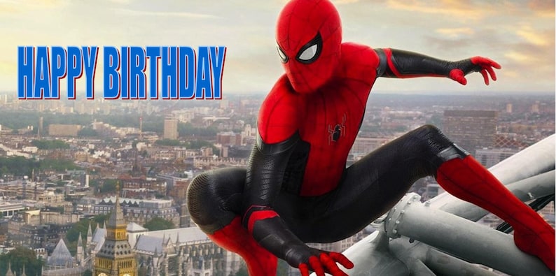 May include: A red and black superhero costume with a spider logo. The superhero is standing on a metal structure with a city skyline in the background. The text "HAPPY BIRTHDAY" is in the top left corner of the image.