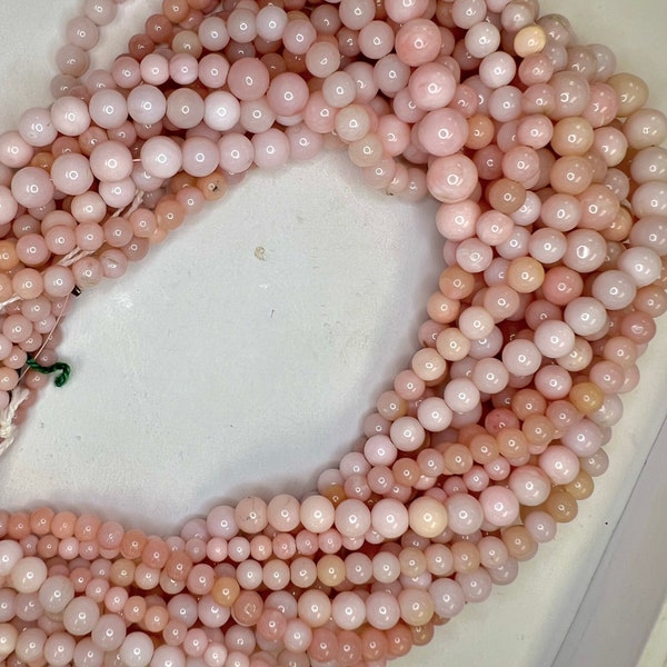 Natural pink opal graduated beads, smooth round different sizes and variation in color. Variation in size, approximately 17” strands.