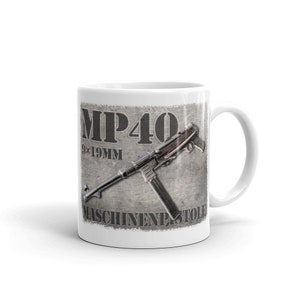 May include: White ceramic mug with a detailed illustration of an MP40 submachine gun. The design includes the text "MP40 9x19MM MASCHINENPISTOLE" in a distressed style. The mug has a standard handle and a glossy finish.