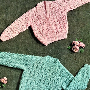 May include: Two knitted cardigans, one pink and one teal, with a lace pattern. The text "& Double Knitting Wool" is at the top of the image and "Colourful Kaiapoi Knitting Wools" is at the bottom.