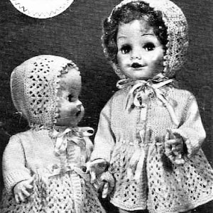 May include: Two dolls wearing crocheted outfits. The dolls are wearing white crocheted hats, jackets, and trousers. The dolls are standing side by side.
