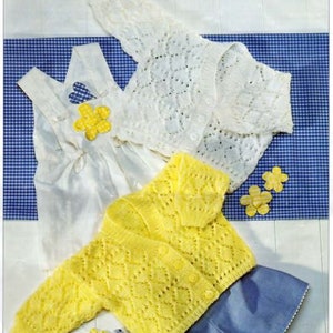 May include: A set of three knitted baby garments: a white cardigan with a lacy pattern, a yellow cardigan with a diamond pattern, and a blue skirt.