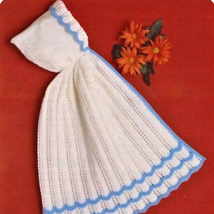 May include: White crocheted baby blanket with a blue scalloped trim. The blanket has a hood and is made with a delicate stitch pattern.