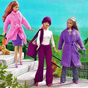 May include: Three knitted outfits for dolls, each in a different shade of purple. The outfits include a long coat, a pantsuit, and a jacket with a skirt. The dolls are not included.