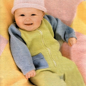 May include: A baby wearing a knitted light blue and yellow romper with a blue pocket. The baby is wearing a pink knitted hat and is sitting on a multi-coloured knitted blanket. The text "Knitting" and "intermediate make" are visible in the image.