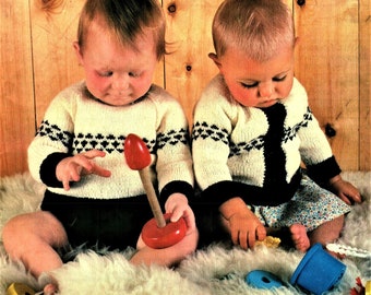 May include: Two babies wearing white and black knitted sweaters with a geometric pattern. The baby on the left is playing with a red and wooden toy. The baby on the right is holding a small toy. The babies are sitting on a white fluffy rug. The text "Babytime" is printed in gold at the bottom of the image.
