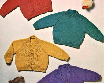 May include: A collection of colorful, knitted sweaters and cardigans in red, teal, yellow, and purple. The red sweater has a cable knit design. The yellow cardigan has buttons. A plush toy duck and teddy bear are also present.