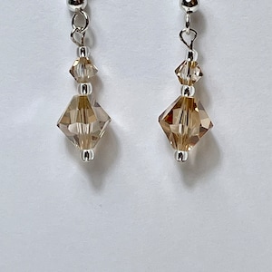 Genuine Swarovski crystal golden shadow earrings. Swarovski Faceted Bicone with Sapphire accents. Prom earrings. Wedding jewelry. Champagne