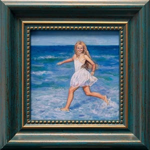 Puede incluir: Pintura al óleo de una persona joven corriendo en el océano, con un vestido blanco. La obra de arte está enmarcada en un marco de madera verde azulado y dorado. El océano es azul con olas blancas.