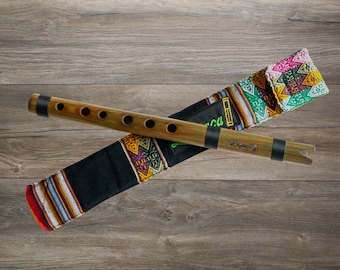 May include: A wooden flute with a black and brown handle and six holes. The flute is in a colorful patterned fabric case with a green label that says "Quena".
