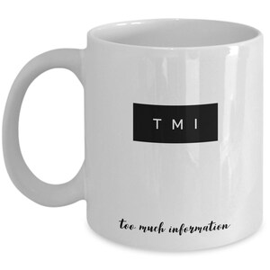 May include: White ceramic coffee mug with black text that reads "TMI" and "too much information".