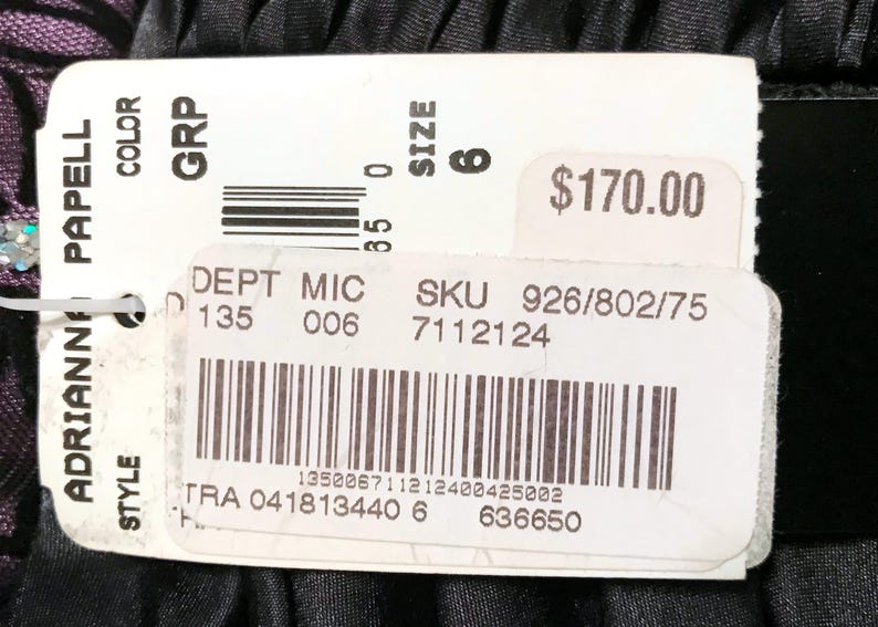 May include: A white tag with the brand name "ADRIANNE PAPELL" and product information. The tag includes the size "6", a department code, and a SKU number. The price is $170.00.