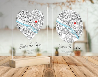 May include: Two clear acrylic plaques with a map of Paris, one in a heart shape and the other in a circle. Both plaques feature the text "Jessica & Tufan 20 Novembre 2002 Paris".