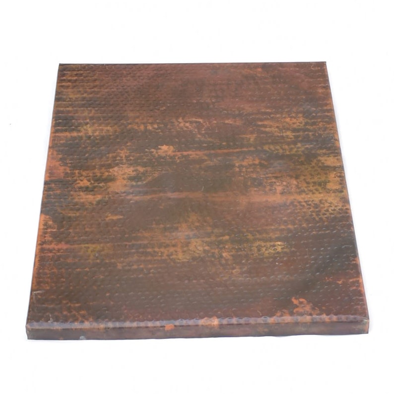 May include: A square copper tabletop with a hammered finish. The copper has a rustic, aged look with brown and orange tones.