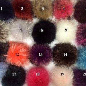 May include: Twenty assorted faux fur pom poms in various colors, including black, white, brown, gray, pink, red, orange, blue, and purple. The pom poms are numbered 1 through 20.