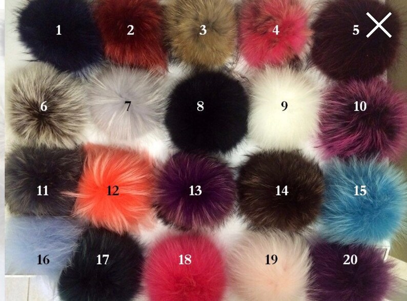 May include: Twenty assorted faux fur pom poms in various colors, including black, white, brown, gray, pink, red, orange, blue, and purple. The pom poms are numbered 1 through 20.