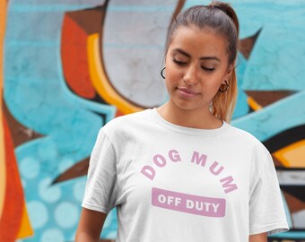 May include: White t-shirt with pink text that reads "Dog Mum Off Duty".